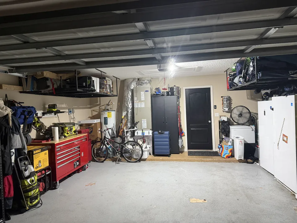 The same Middleburg garage after clearing, with wall shelving, a tool chest, bikes stored and a clear floor