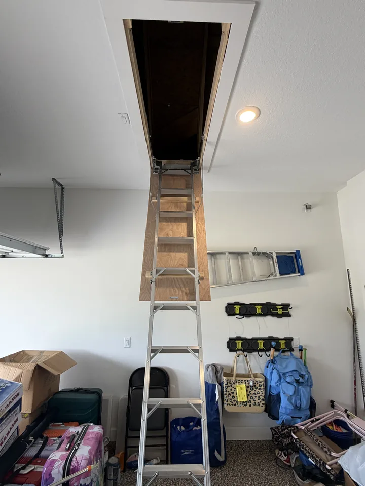The same SilverLeaf garage after: a folding aluminum attic ladder pulled down from the opening to the garage floor