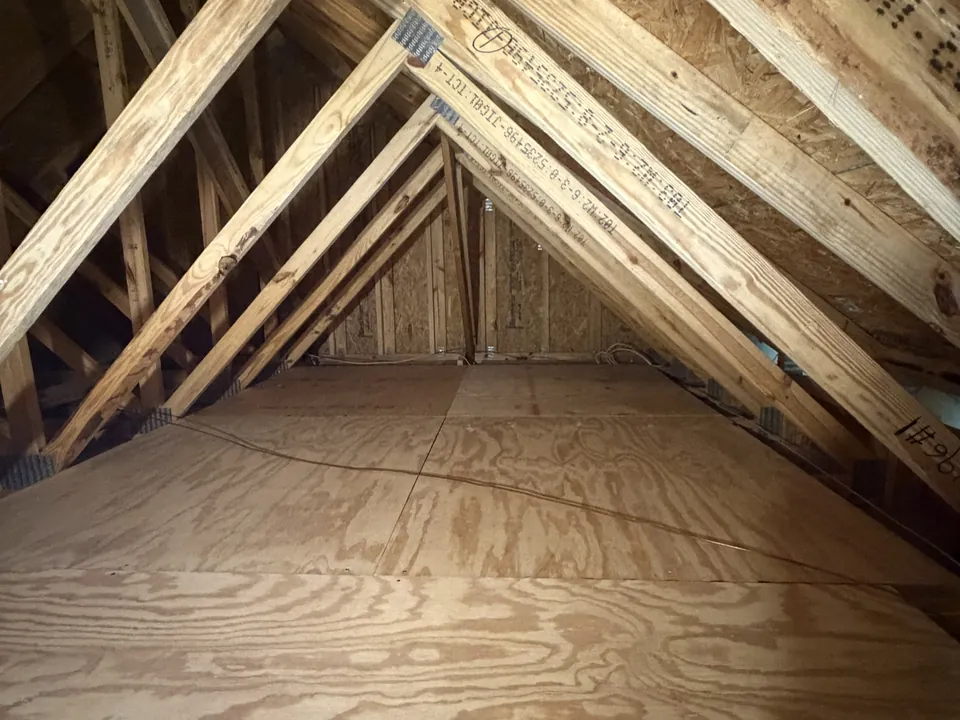 The same SilverLeaf attic after decking: plywood sheets fixed across the joists forming a walkable storage platform