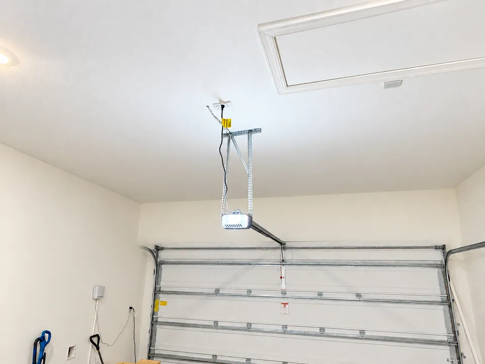 Empty SilverLeaf garage ceiling before installation, with only the door opener mounted